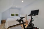 Second floor bedroom with queen size bed and peloton
